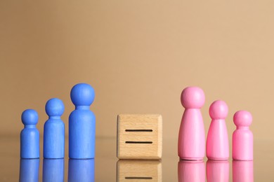 Gender equality concept. Male and female figures on beige background