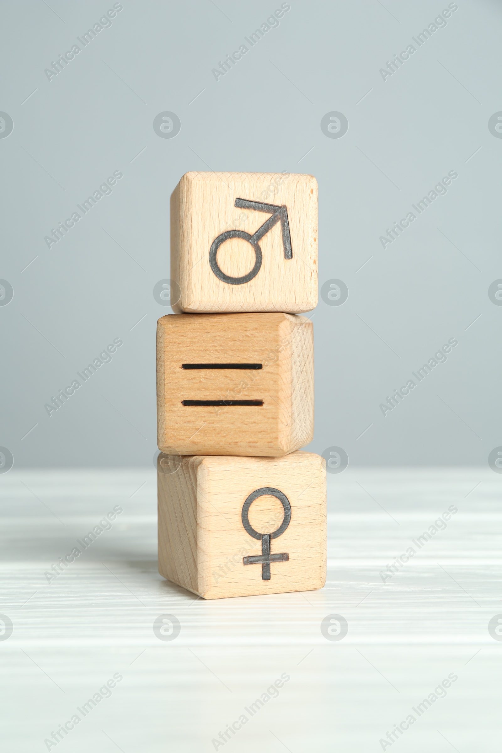 Photo of Gender equality concept. Cubes with male and female symbols on white table