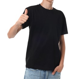 Teenage boy wearing black t-shirt and showing thumbs up on white background, closeup