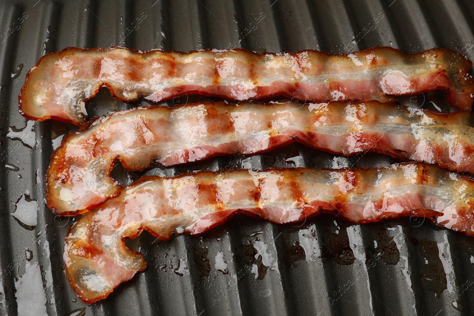 Photo of Slices of bacon on grill, above view