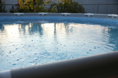 Photo of Above ground swimming pool in garden, closeup