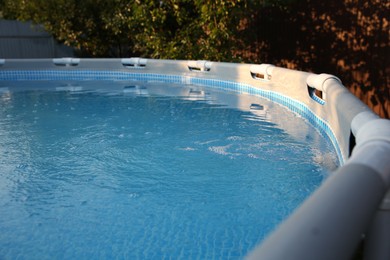 Photo of Above ground swimming pool in garden, closeup