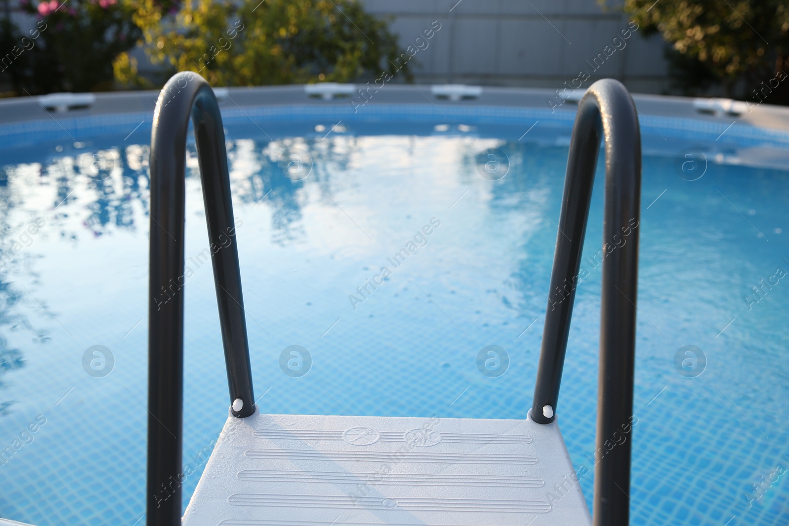 Photo of Above ground swimming pool with ladder outdoors, closeup