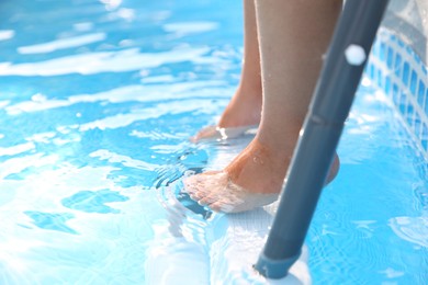 Photo of Little girl resting in swimming pool, closeup. Space for text