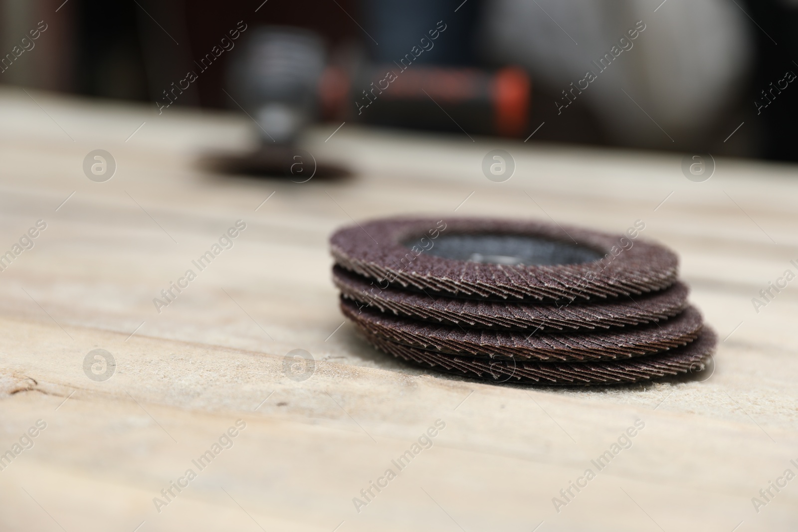 Photo of Many grinding wheels on wooden table, space for text