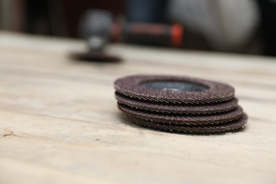 Many grinding wheels on wooden table, space for text