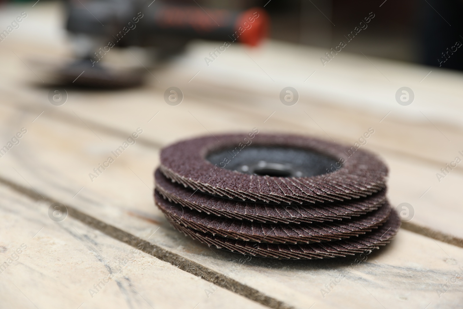 Photo of Many grinding wheels on wooden table, closeup