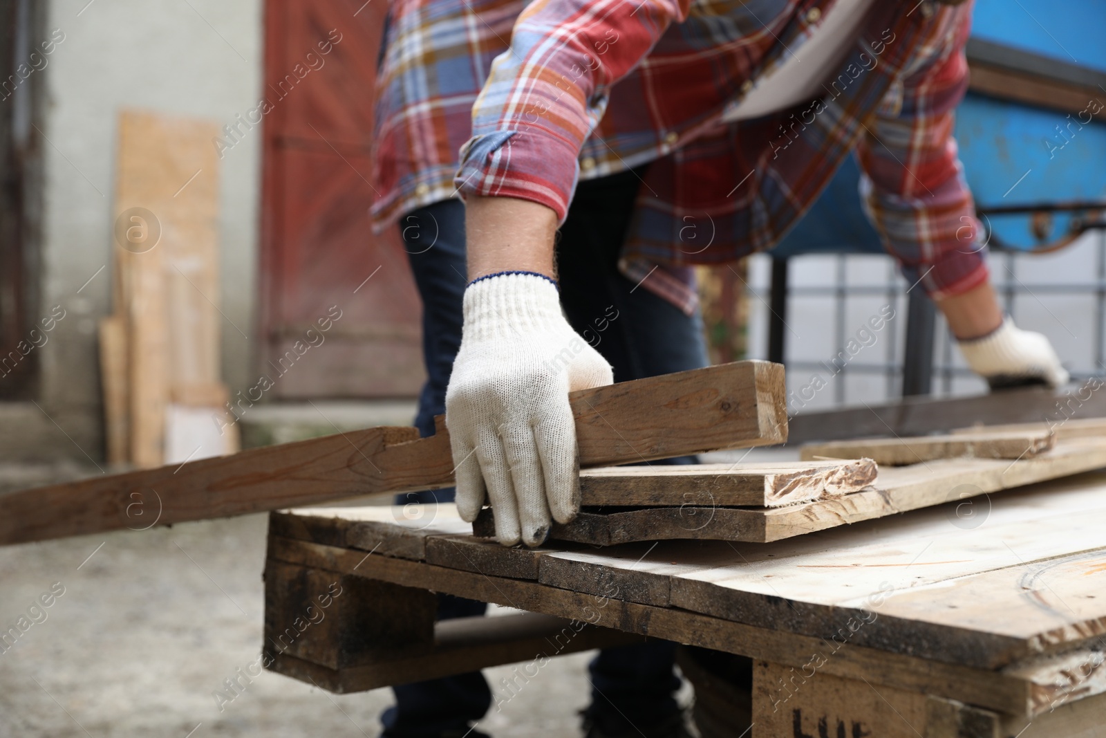 Photo of Man working with wood in backyard, closeup