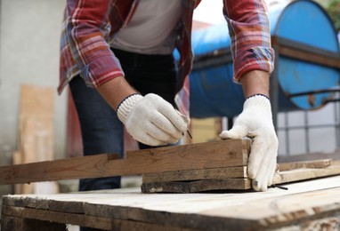 Photo of Man working with wood in backyard, closeup