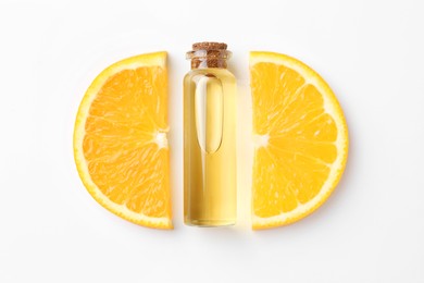 Bottle of essential oil and orange on white background, flat lay