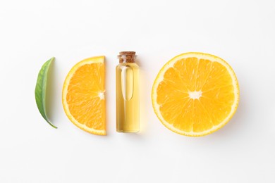 Photo of Bottle of essential oil, orange and green leaf on white background, flat lay