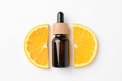 Photo of Bottle of essential oil and orange on white background, flat lay