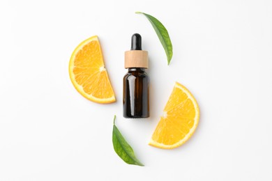 Photo of Bottle of essential oil, orange and green leaves on white background, flat lay