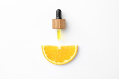 Photo of Dropper of essential oil and orange on white background, top view