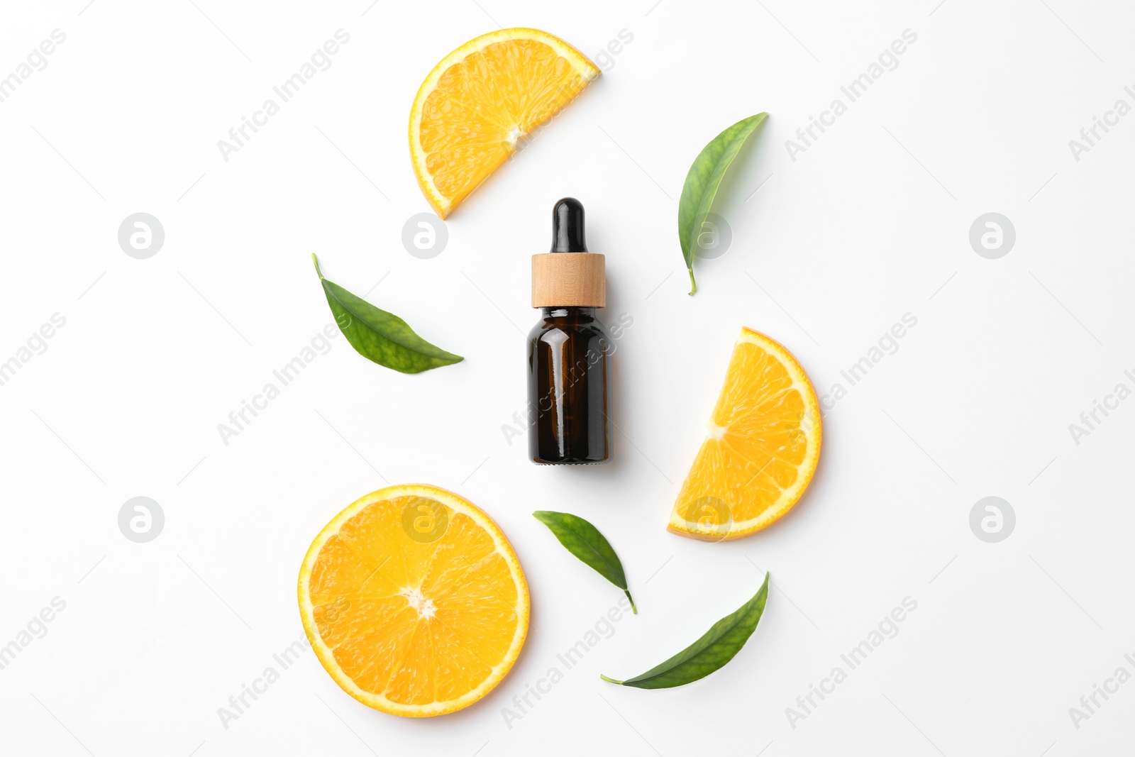 Photo of Bottle of essential oil, orange and green leaves on white background, flat lay