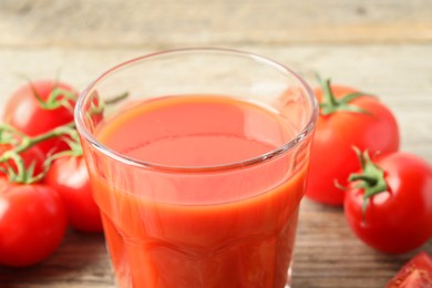 Fresh tomato juice in glass on table, closeup