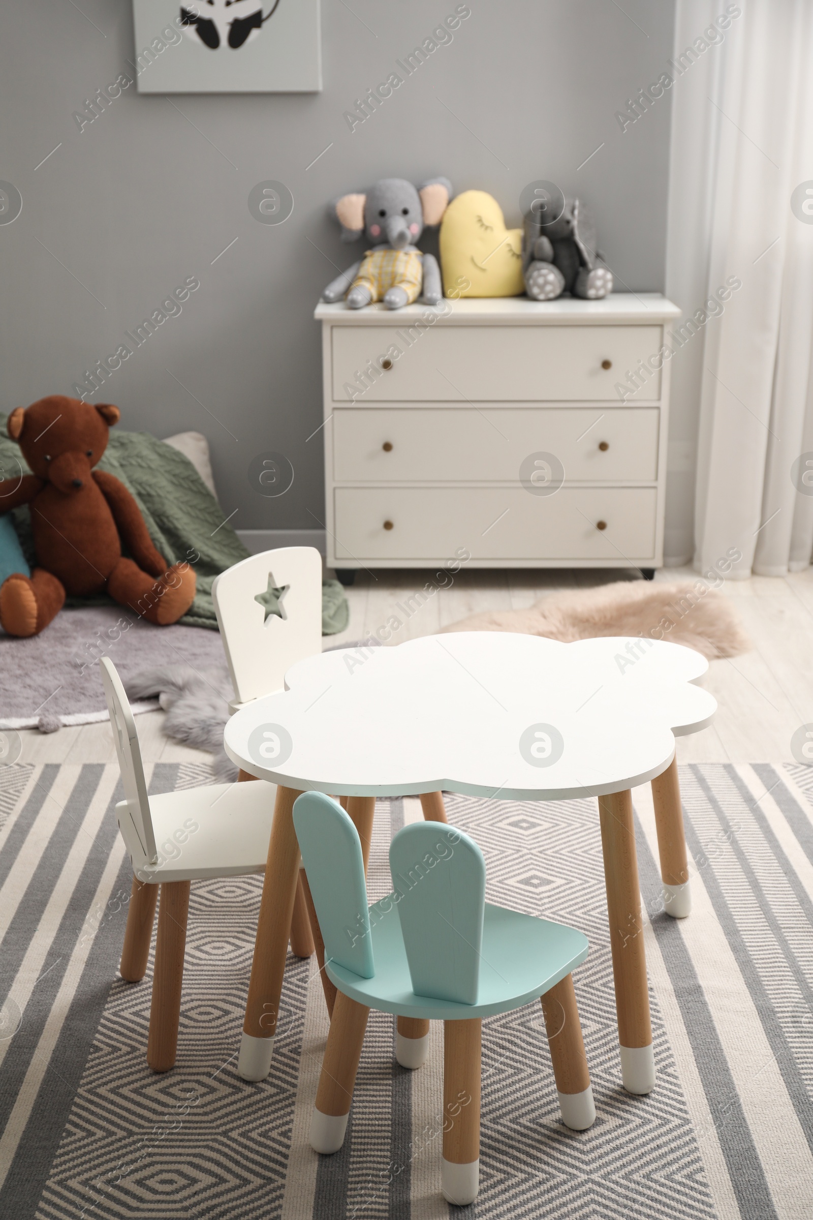 Photo of Stylish child room interior with modern furniture and toys