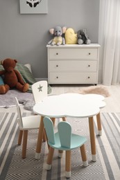 Photo of Stylish child room interior with modern furniture and toys