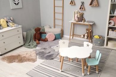 Photo of Stylish child room interior with modern furniture and toys