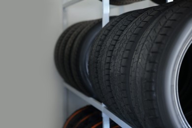 Photo of Group of car tires in auto store, closeup. Space for text