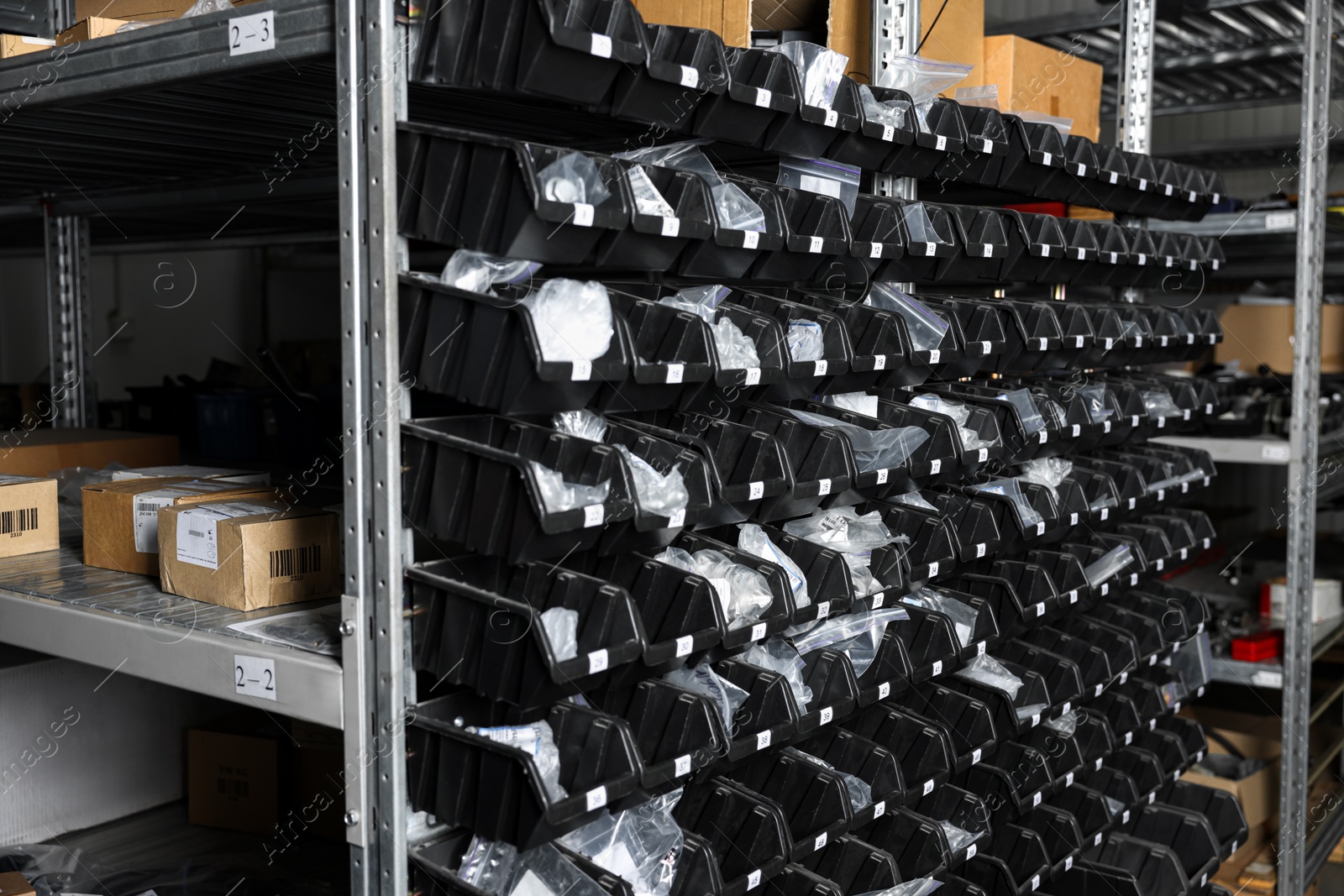 Photo of Many plastic boxes for storing car parts in auto store