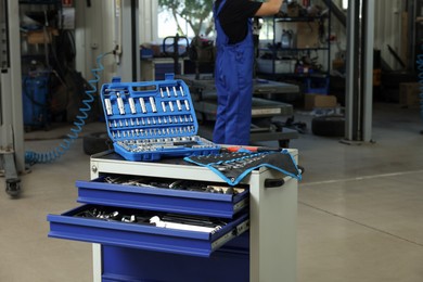 Auto mechanic`s tools at automobile repair shop, selective focus