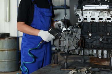 Auto mechanic fixing motor at automobile repair shop, closeup. Car diagnostic