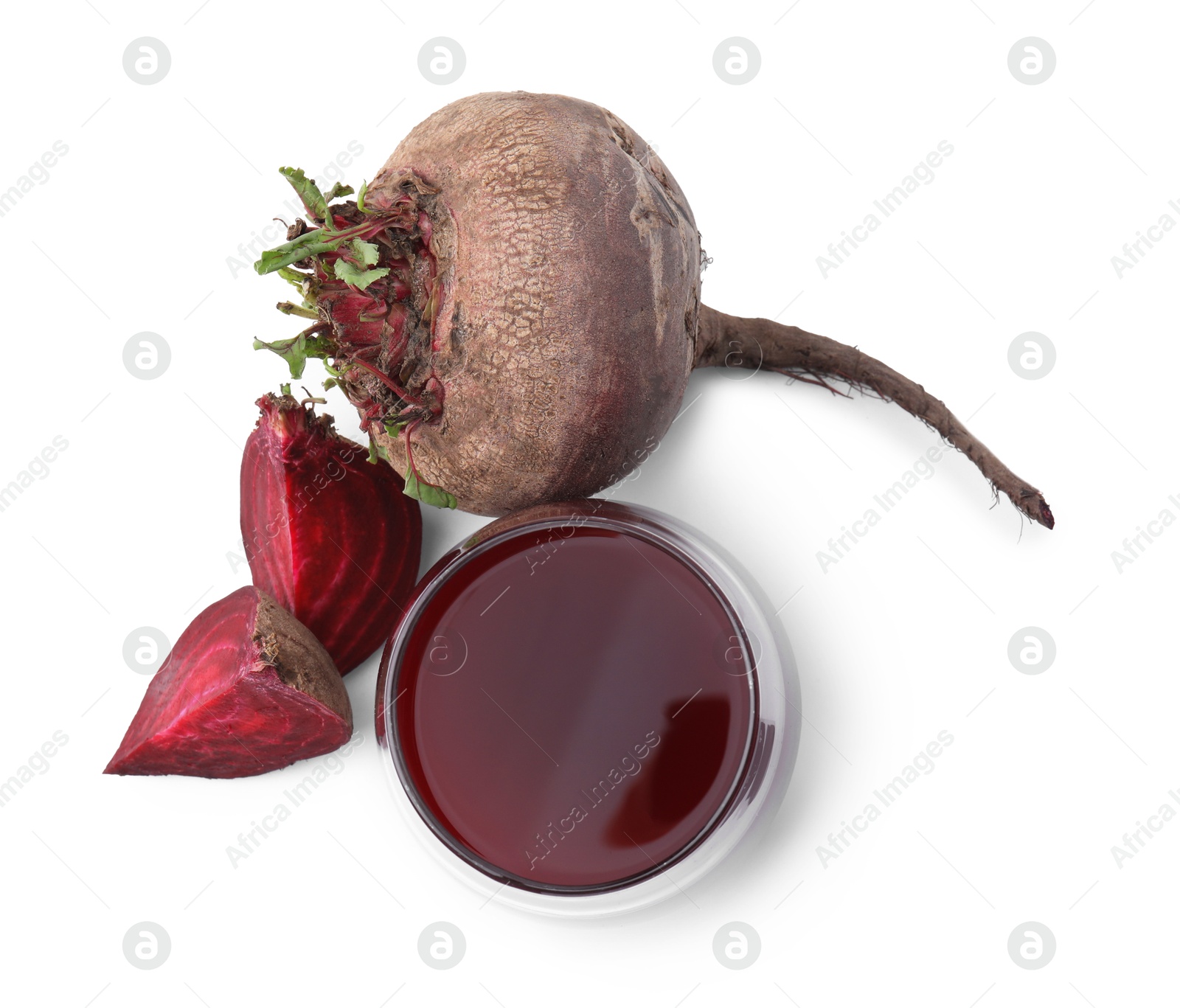 Photo of Fresh beet juice in glass and ripe vegetables isolated on white, top view