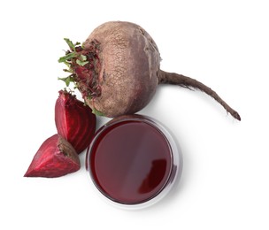 Photo of Fresh beet juice in glass and ripe vegetables isolated on white, top view