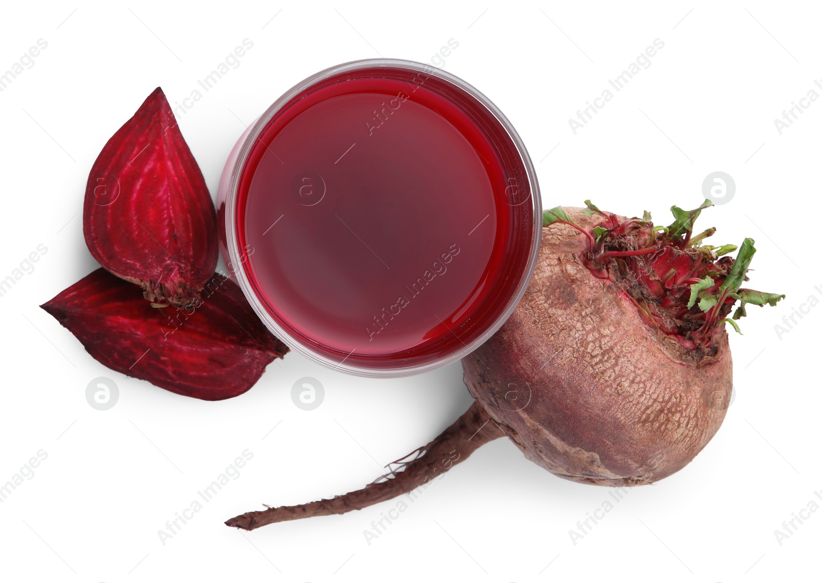 Photo of Fresh beet juice in glass and ripe vegetables isolated on white, top view