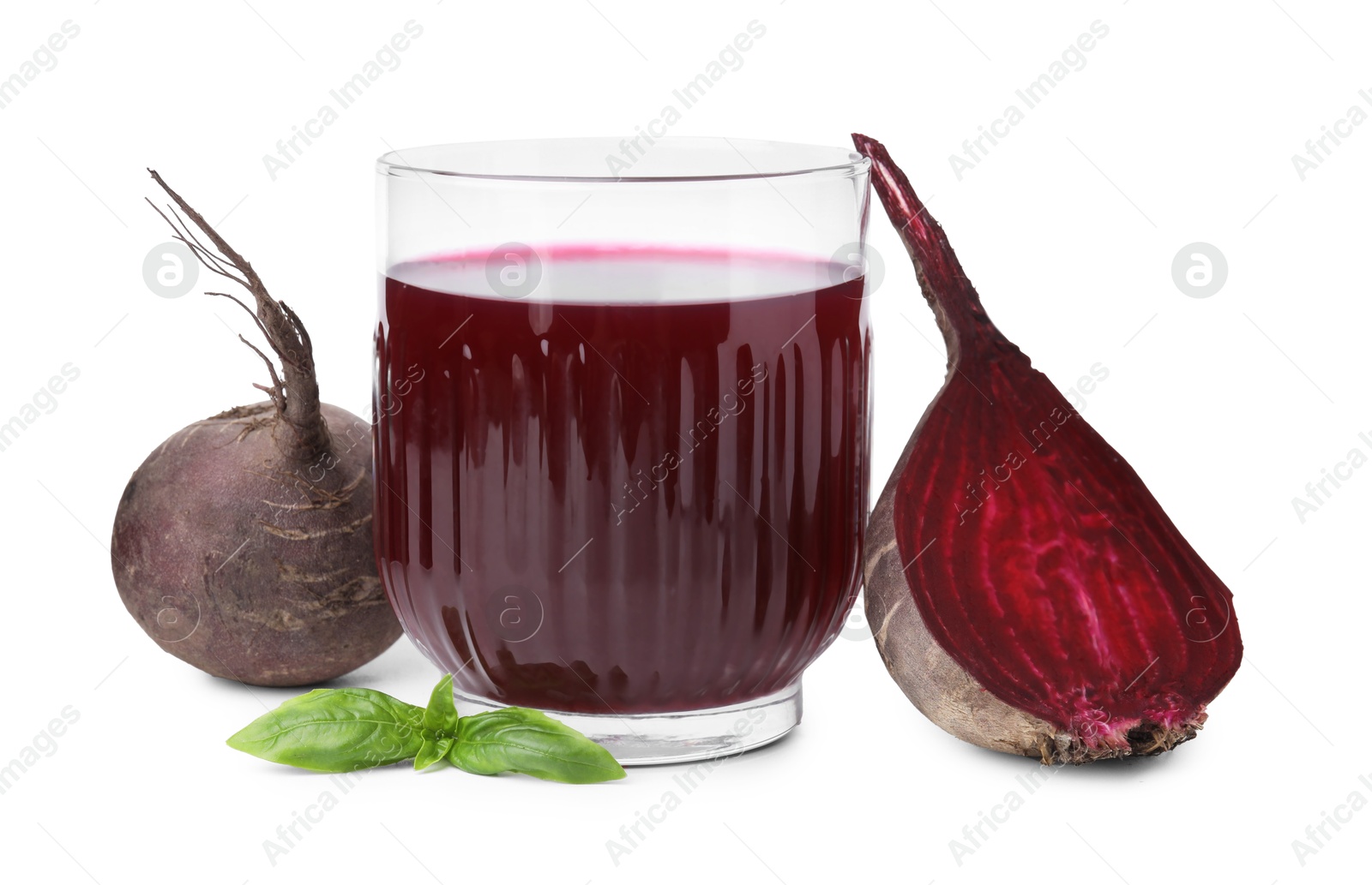 Photo of Fresh beet juice in glass, ripe vegetables and basil isolated on white