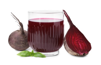 Photo of Fresh beet juice in glass, ripe vegetables and basil isolated on white