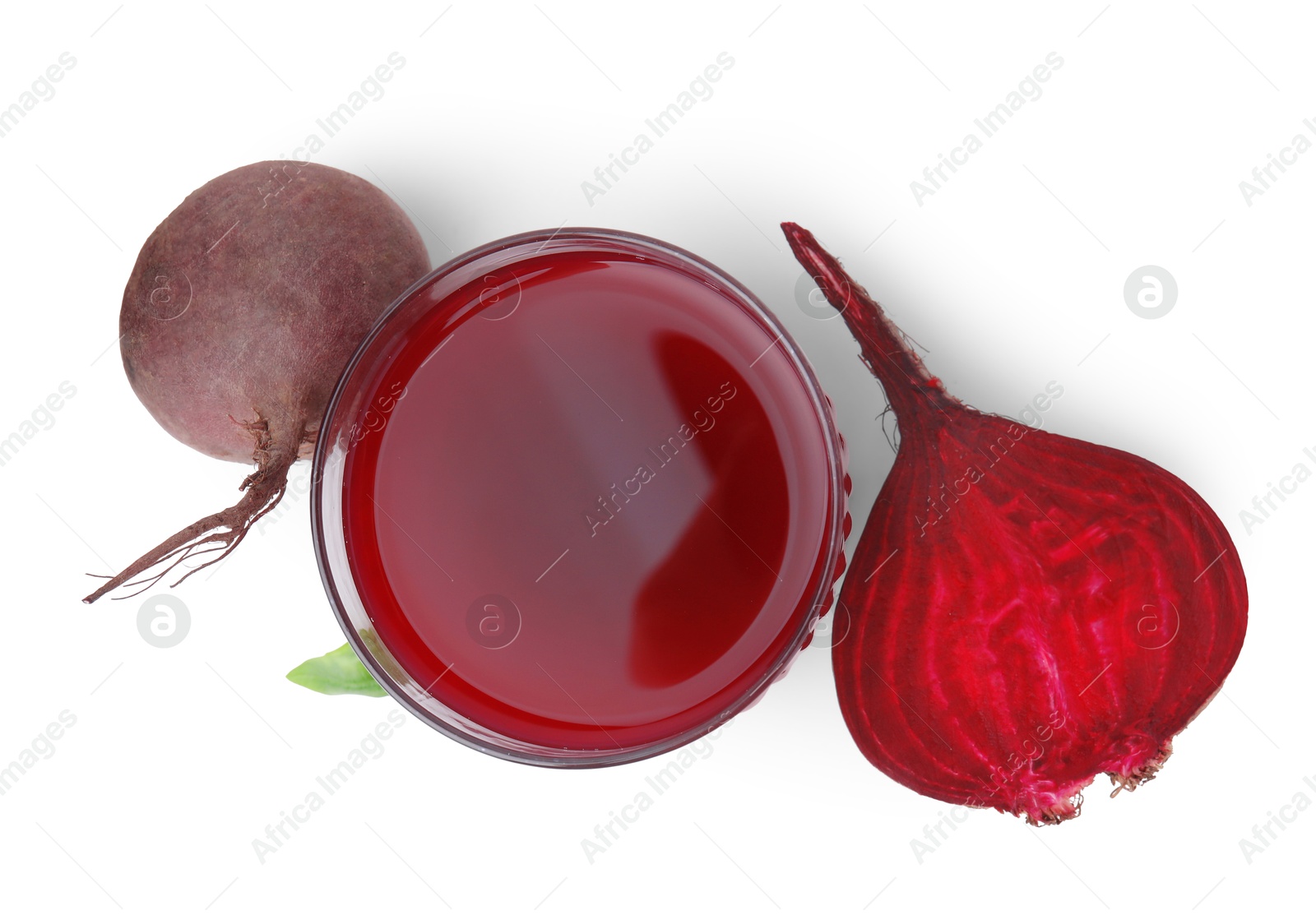 Photo of Fresh beet juice in glass and ripe vegetables isolated on white, top view