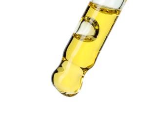 Photo of Dripping essential oil from pipette on white background