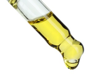 Photo of Dripping essential oil from pipette on white background