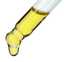 Dripping essential oil from pipette on white background