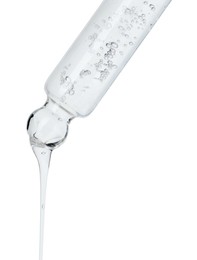 Photo of Dripping cosmetic serum from pipette on white background