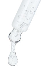 Photo of Dripping cosmetic serum from pipette on white background