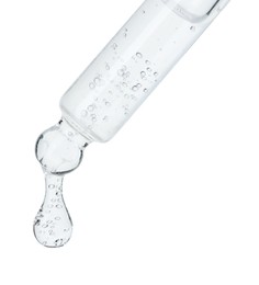 Dripping cosmetic serum from pipette on white background