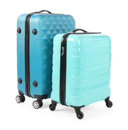 Photo of Two new light blue suitcases isolated on white