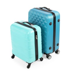 Photo of Two new light blue suitcases isolated on white