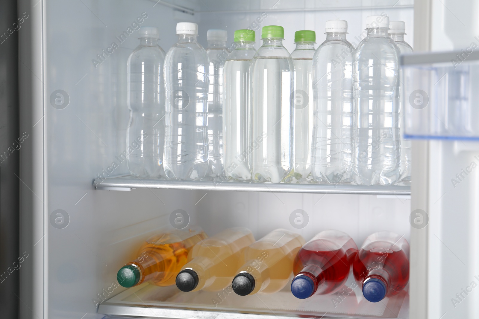 Photo of Many different cold drinks in refrigerator, closeup