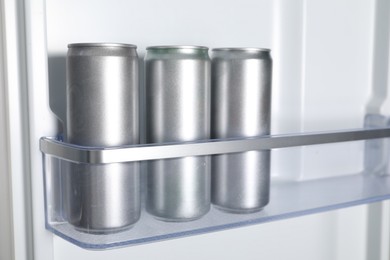 Photo of Many cans of beer in refrigerator, closeup