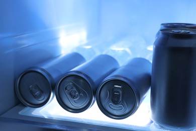 Many cans of beer in refrigerator, closeup