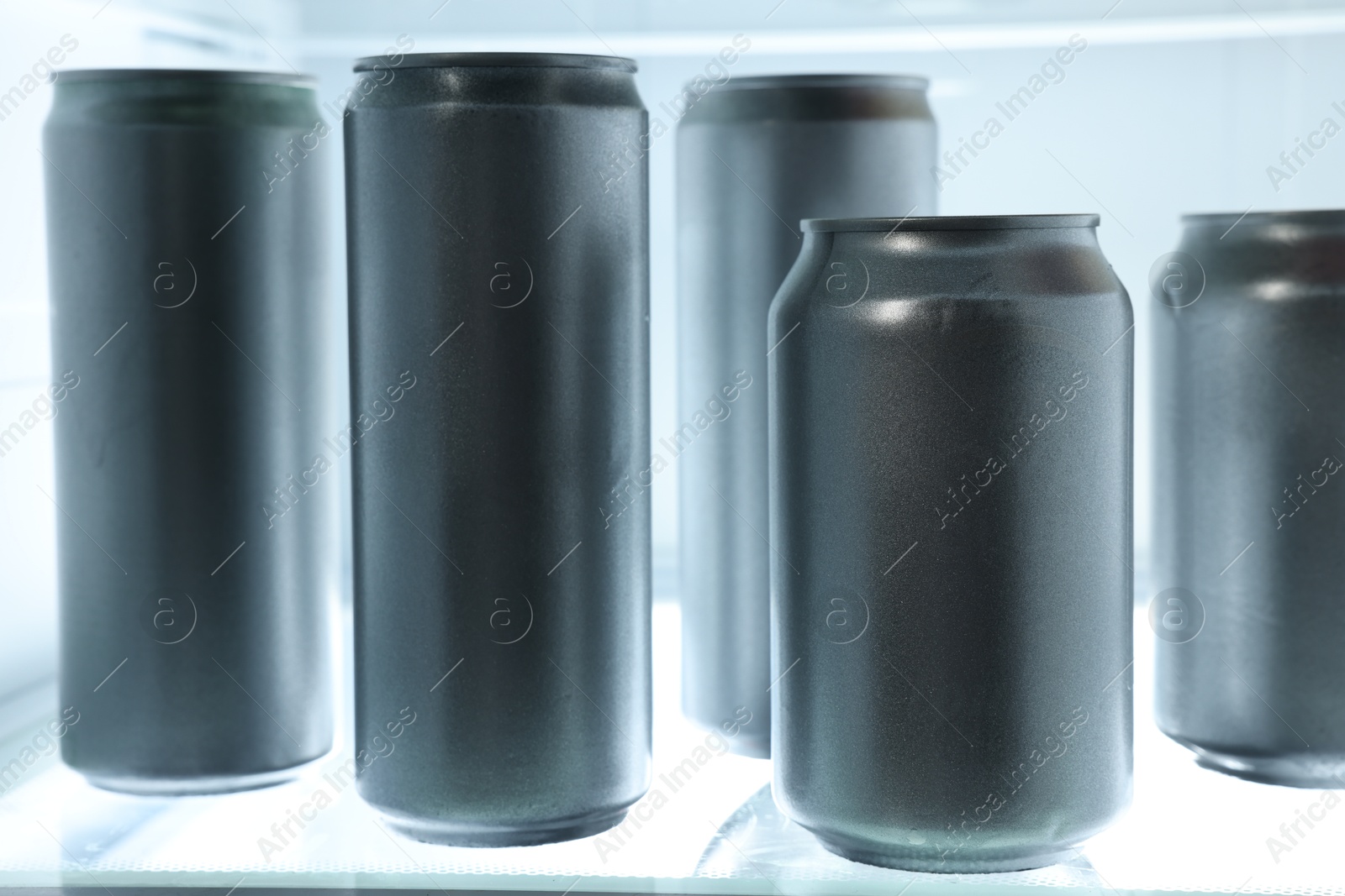 Photo of Many cans of beer in refrigerator, closeup