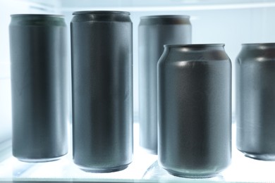 Many cans of beer in refrigerator, closeup