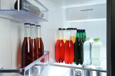 Photo of Many different cold drinks in refrigerator, closeup