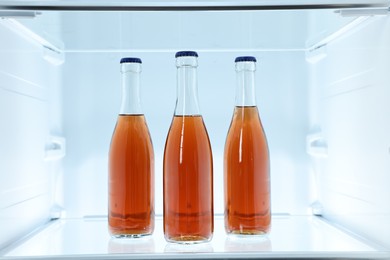 Photo of Many bottles of juice in refrigerator, closeup