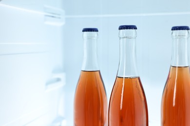 Many bottles of juice in refrigerator, closeup