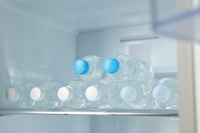 Many bottles of water in refrigerator, closeup